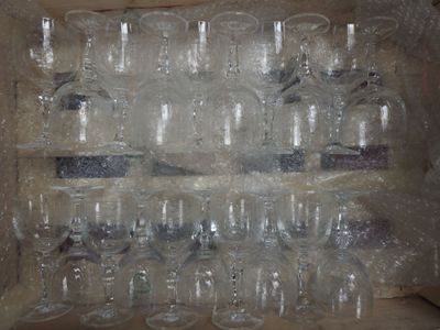 many empty wine glasses in a box on the table
