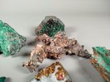several pieces of green and brown colored rocks on a white surface