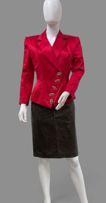 a mannequin wearing a red jacket and black skirt