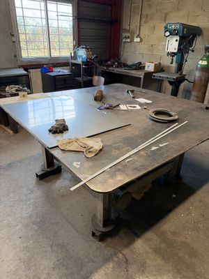 une table sur laquelle se trouvent quelques outils, dans une pièce
