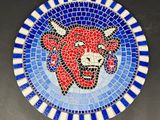 a picture of a blue and white plate with a red bull on it