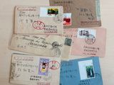 many different types of letters and envelopes laid out on a table