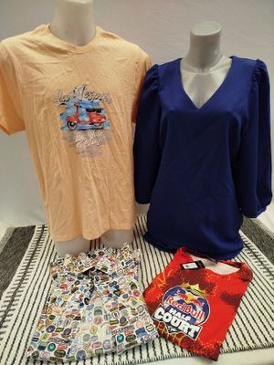 two women ' s shirts and a t - shirt sitting on a table next to each other