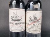 two bottles of wine sitting next to each other on a table