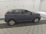 a blue car parked in a garage with a checkered floor