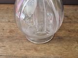a glass vase with a flower in it on a wooden table