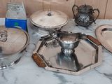 a table with a lot of silver items on it