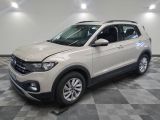 the white volkswagen suv is parked in the garage on a checkered floor