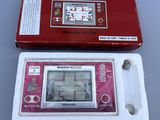 a red and white electronic game in a box
