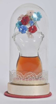 a glass dome with flowers in it on a table