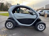a small car that is parked on the side of the road