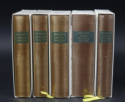 three books are lined up in a row on a black surface