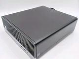 the back of a small black computer on a white surface