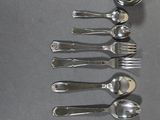 six spoons and two spoons on a table