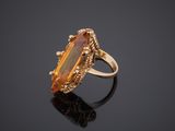 a gold ring with a large citrine stone in the center