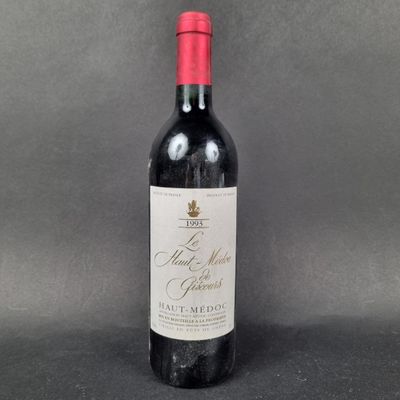 a bottle of red wine sitting on top of a table