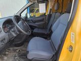a yellow van with a blue seat and steering wheel