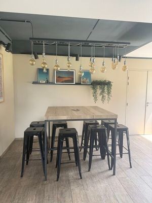 a table with six stools in the middle of the room