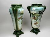 two vases sitting side by side on a white surface