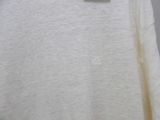 the shirt is white and has a small logo on it
