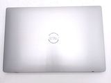 dell laptop computer with dell logo on the screen on a white surface