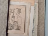 an open book with a drawing of a castle in it