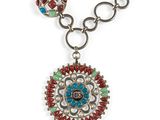 a close up of a necklace on a white background