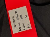 a red tag on a black shirt with a black tie