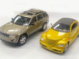 two toy cars sitting next to each other on a white surface