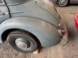 an old car that is parked in a garage