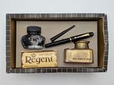 a box with a pen, ink bottle, and other items in it