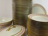 a lot of plates and bowls sitting on a table
