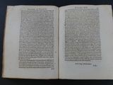an open book on a table with a black background