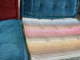 three couches that are sitting on a pallet in a room