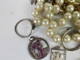 many different types of jewelry on a white surface