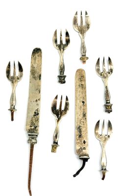 a lot of forks and spoons that are on the table