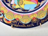 a colorful plate with a picture of a woman on it