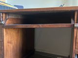 a wooden desk with a drawer underneath it in a room