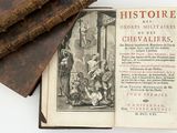 an old book that is open on a white surface