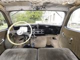 dashboard of an old car with two seats and a steering wheel