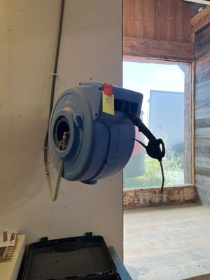 un ventilateur bleu posé contre le mur d'une pièce