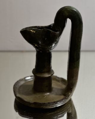 a small glass vase with a bird on it