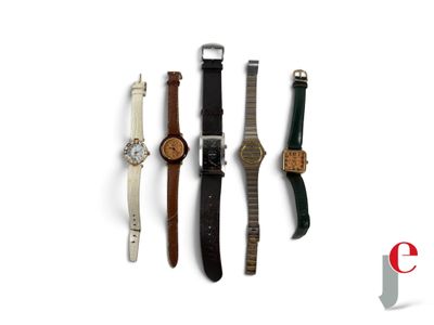 four different watches are lined up on a white surface
