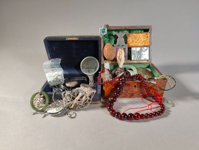 two pieces of jewelry sitting in a box on a table
