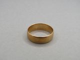 a close up of a gold ring on a table