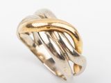 a close up of a gold ring on a white surface