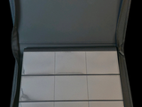 a black case with white squares in it on a black background