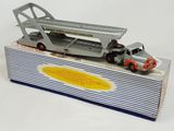 a toy truck with a crane on top of it in a box