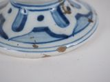 a blue and white vase on a white table