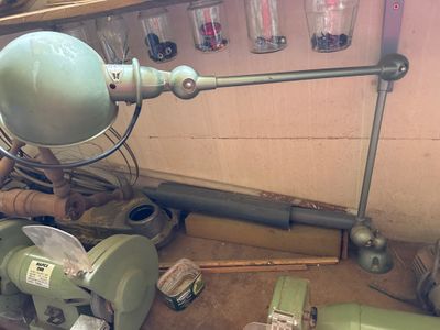 une photo d'une pièce où se trouvent tout un tas d'outils et une lampe